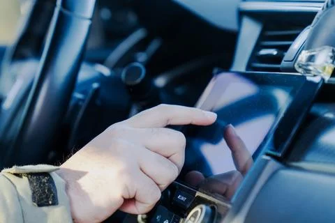 Hand operating touchscreen display in a modern vehicle 写真素材