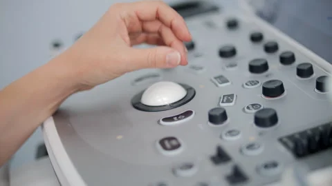 Hand operating ultrasound machine control knob Stock Footage 317761654