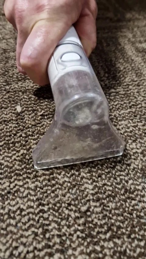 Hand Operating Wet Vacuum Extraction Cleaning Nozzle on Brown Carpet Stock Footage 339082658