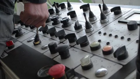 Hand of operator using joystick on control panel of road paving machine Stock Footage 158050014