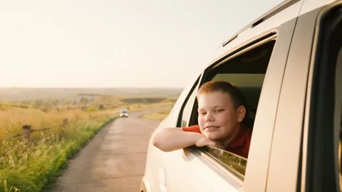Hand out car window, wind blowing face from car window, child boy catching wind Stock Footage 280945507
