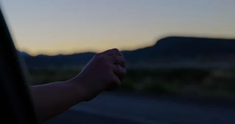 Hand out the window enjoying summer at sunset - slow motion Stock Footage 307446705