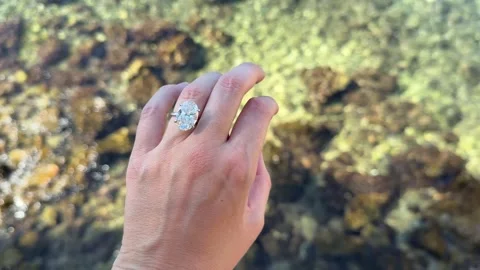Hand with oval diamond ring by the Adriatic Sea in Croatia Stock Footage 319697765