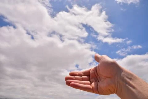 Hand over a Cloudy Sky Stock Photos