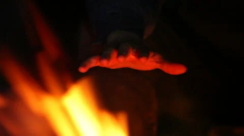 Hand over the fire. Rack focus Video stock 63371418