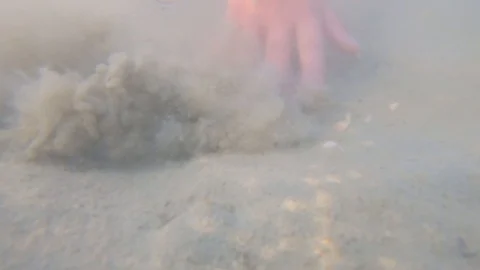 Hand over ground underwater, sand stirring in cloudy water Stock Footage 115525894