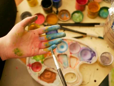 Hand in the paint of an art school student Stock Photos