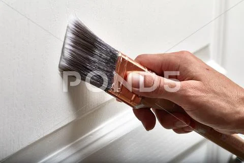 Hand with a paint brush. Stock Photos