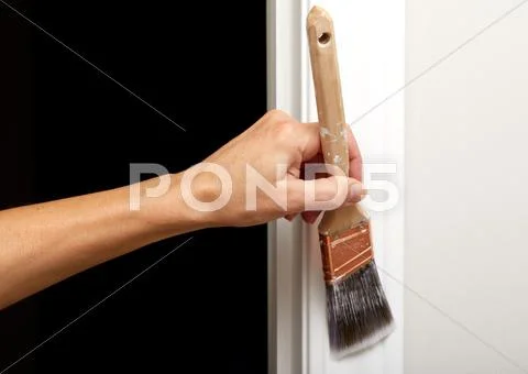 Hand with a paint brush. Stock Photos