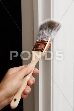 Hand with a paint brush. Stock Photos