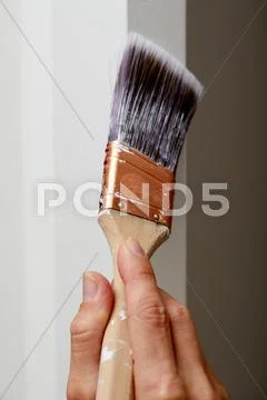 Hand with a paint brush. Stock Photos