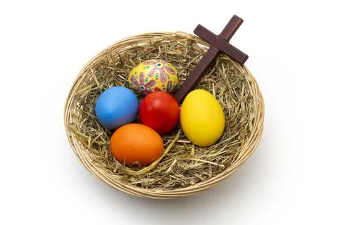Hand Painted Christian Easter Eggs and Wooden Cross in Wicker Basket Stock Photos