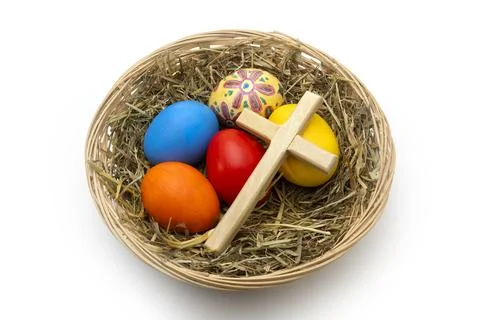 Hand Painted Christian Easter Eggs and Wooden Cross in Wicker Basket Stock Photos