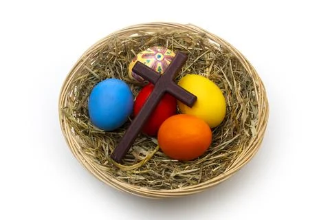 Hand Painted Christian Easter Eggs and Wooden Cross in Wicker Basket Stock Photos