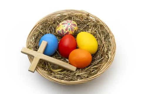 Hand Painted Christian Easter Eggs and Wooden Cross in Wicker Basket Stock Photos