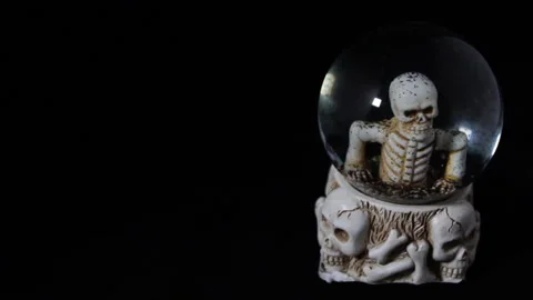 A hand painted day of the dead skull candle lit on a black background Video stock 139659852
