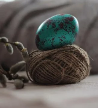 Hand painted Easter egg on soft background, backlight Stock Photos