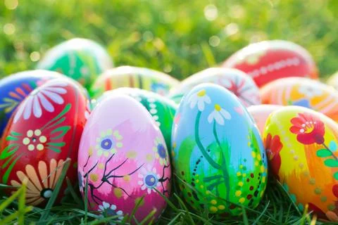 Hand painted Easter eggs on grass. Spring patterns art, unique. Stock Photos