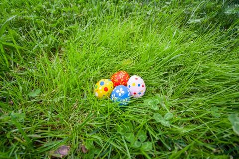 Hand painted Easter eggs hidden on the grass Stock Photos