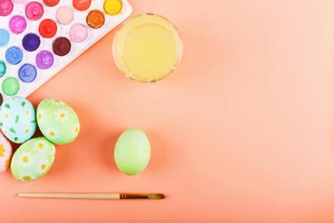 Hand painted Easter eggs, paints and brushes on a table. Preparation for the  Stock Photos