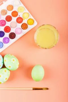 Hand painted Easter eggs, paints and brushes on a table. Preparation for the  Stock Photos