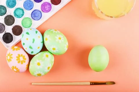 Hand painted Easter eggs, paints and brushes on a table. Preparation for the  Stock Photos