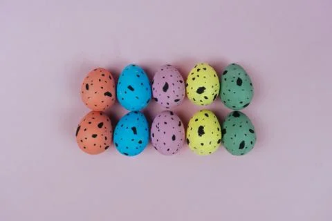 Hand painted Easter quail eggs isolated on pink background. Happy Easter and Stock Photos
