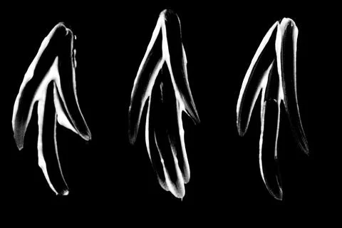 Hand painted glossy arrow pointers on black background Stock Photos