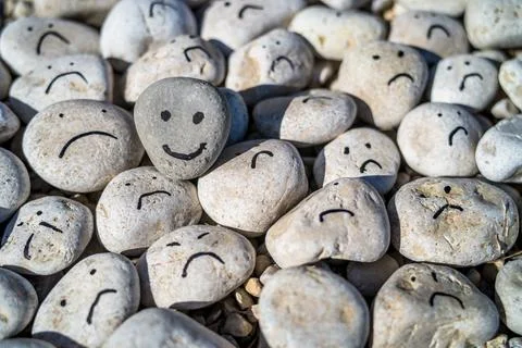 Hand painted happy face on a small stone Stock Photos