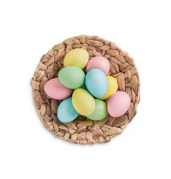 Hand painted pastel Easter eggs in wicker basket isolated on white background Stock Photos