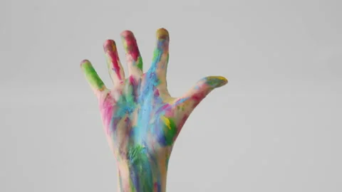 Hand painted in rainbow colors rises up and shows an open palm gesture Stock Footage 158505413