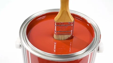 Hand of painter dipping a brush into a bucket with red paint , slow motion Stock Footage 107828200