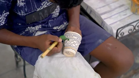 Hand painting a blue pattern on a ceramic cup, Fes, Morocco Stock Footage 348351267