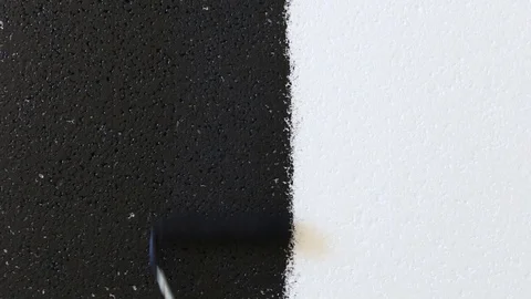 Hand paints foam polystyrene black. Video stock 129834947