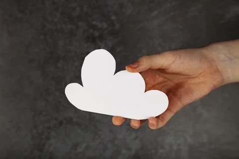 Hand with paper cloud silhouette Stock Photos