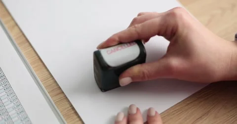 The hand on paper puts the stamp canceled, close-up Stock Footage 243924650