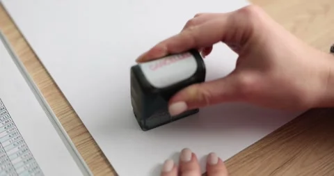 The hand on paper puts the stamp canceled, close-up Stock Footage 258909082