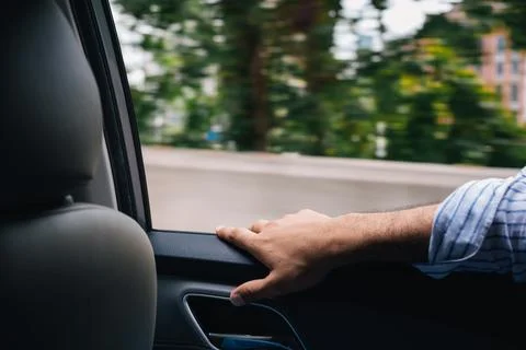Hand of passenger on a taxi window during a trip while the car is Foto stock