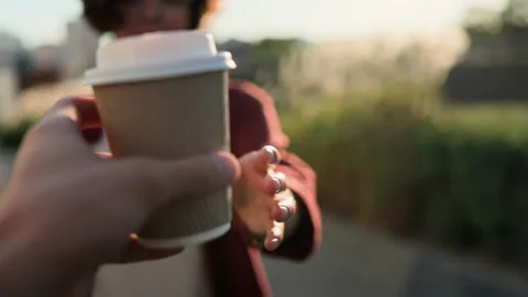Hand passes cup of coffee to other hand, Paper cup in hand Girl holding coff Stock Footage 220370435