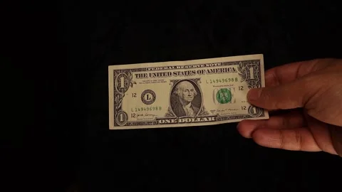 Hand Passing a $1 Bill – Simple Financial Exchange or Payment Concept Stock Footage 297879513