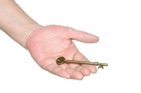Hand passing an old key Stock Photos