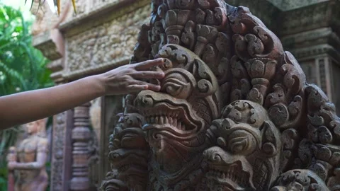 Hand passing on the stone, exotic sculpture of tropical temple.  Stock Footage 219508397