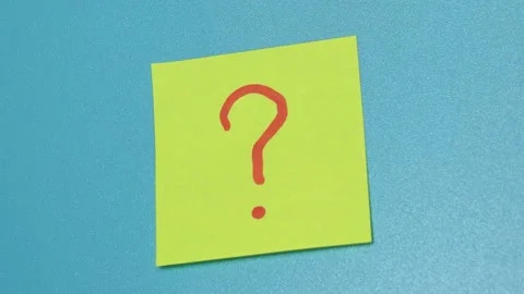 Hand pastes a sticker with a question mark from the blue wall. Stock Footage 159234855