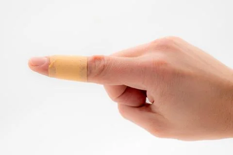 A hand with a patch on the forefinger, isolated against a white background Stock Photos