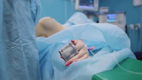 Hand with a patient catheter on the operating table. Surgeon Stock Footage 124405644