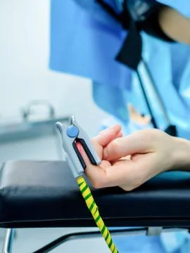 Hand of the patient lying on the operating table. Stock Photos