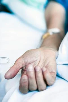 Hand of patient in serious condition is given a medicine through a dropper (h Stock Photos