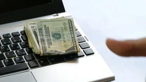 Hand paying throwing buch of dollar us banknotes or laptop keyboard Stock Footage 89444093