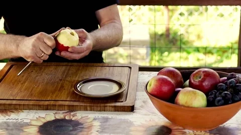 Hand peeling apple, focus on hands, 120fps Видео 132432651