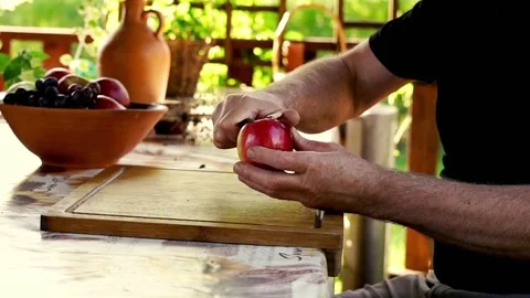 Hand peeling apple, focus on hands, 120fps Stock Footage 132432943